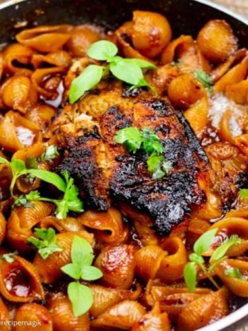 Cajun Chicken Pasta in a skillet garnished with basil