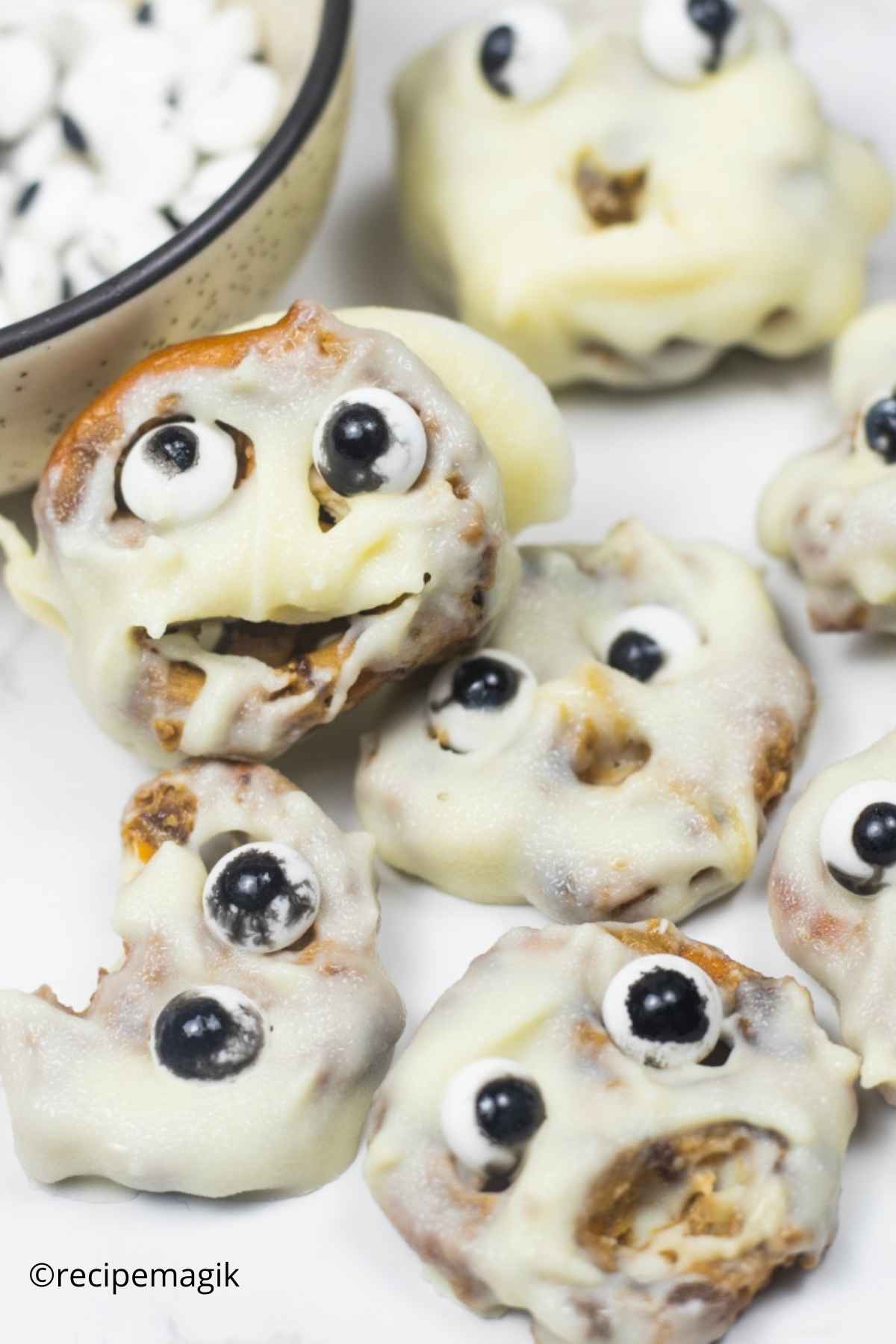 pretzel coated in white chocolate with candy eyeballs