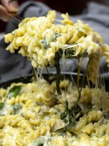 cheesy spinach pasta with spatula