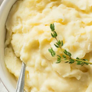 garlic mashed potato with rosemary and a spoon