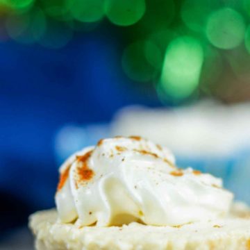 eggnog cheesecake with whipped cream and nutmeg