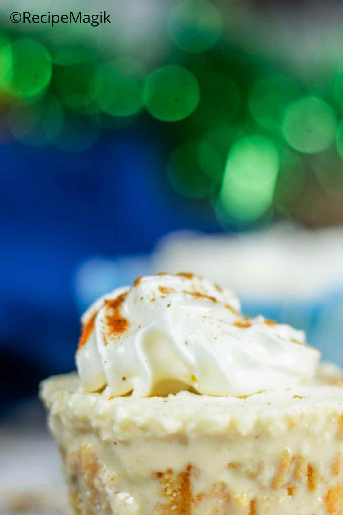 closeup of eggnog cheesecake with whipped cream frosting