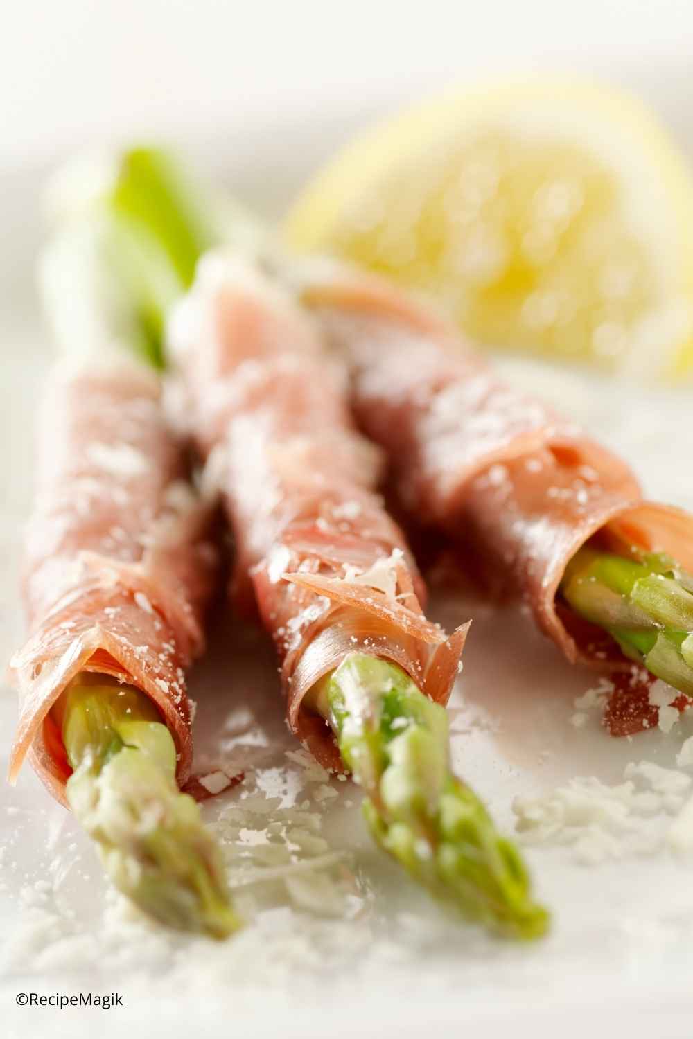 asparagus wrapped with prosciutto and topped with lemon and parmesan