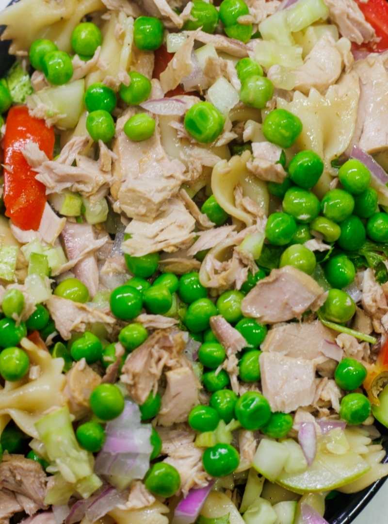 tuna pasta salad topped with fresh green peas