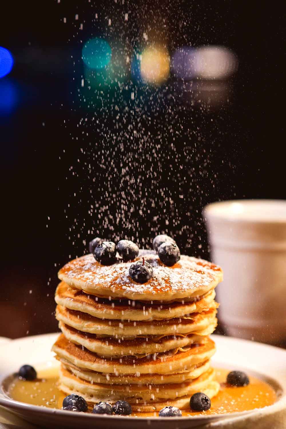 gingerbread pancakes with blueberries on top and dusted with sugar