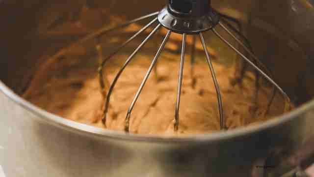 mixing cinnamon roll dough in stand mixer