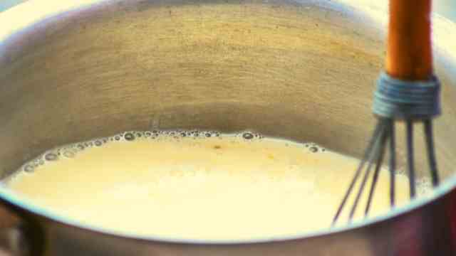 whisking eggnog in a saucepan