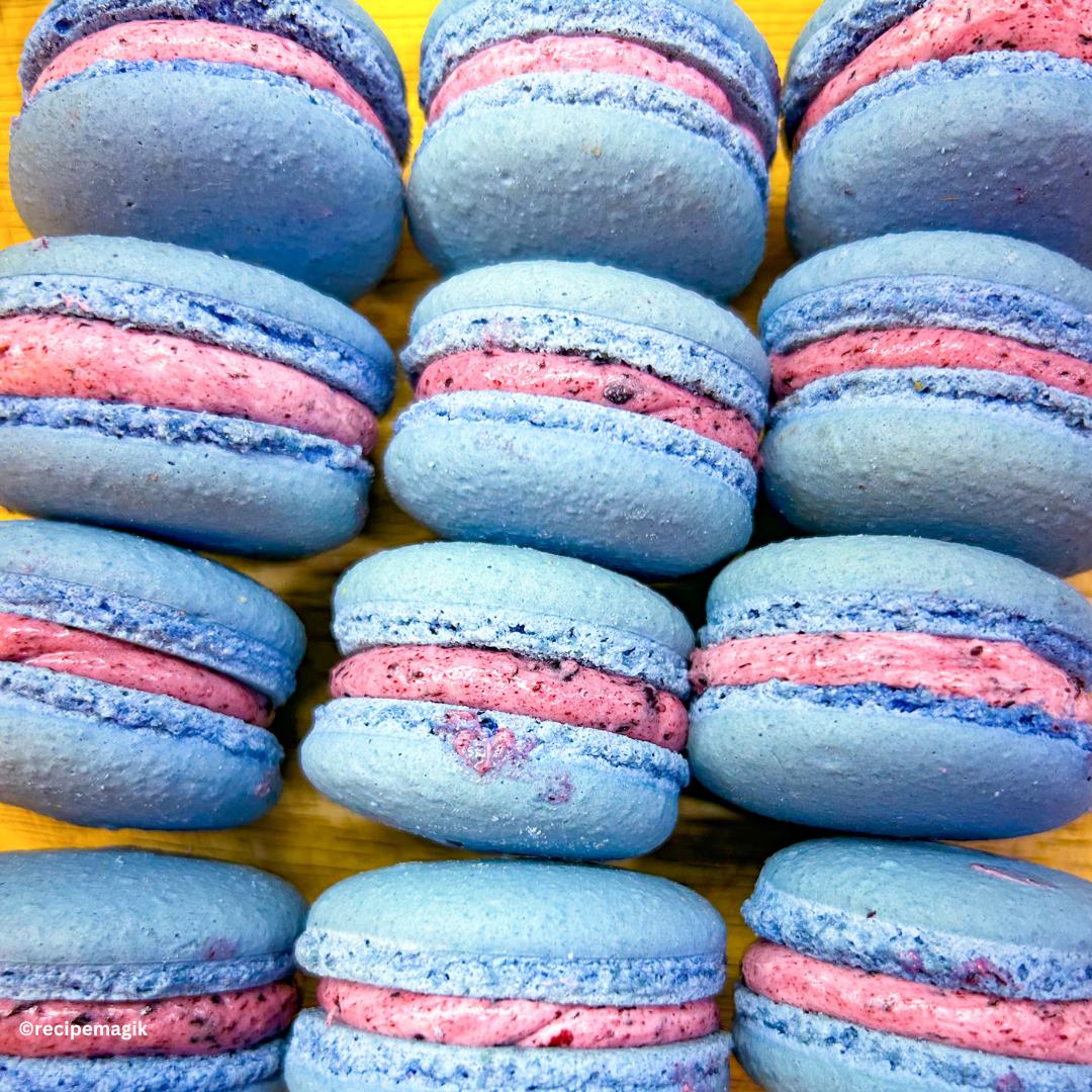 blueberry macarons against a yellow cutting board