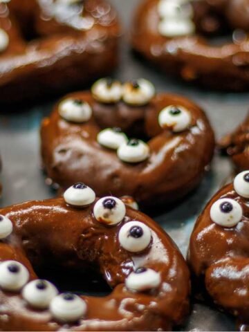 chocolate covered donuts topped with candy eyes