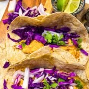 Baja Chicken Tacos served inside warm tortillas topped with mexican slow and cilantro lime
