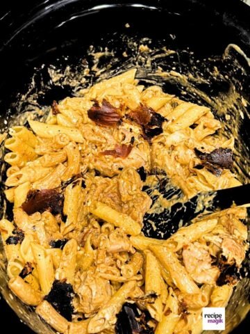 Slow Cooker Cajun Ranch Chicken Pasta with crispy bacon on top
